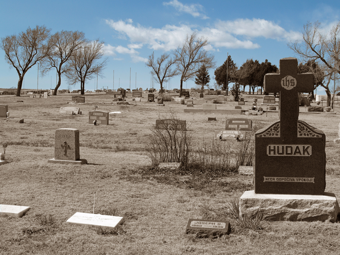 Cemetary in Calahan CO showing grave markers on a gentle-sloped hillside