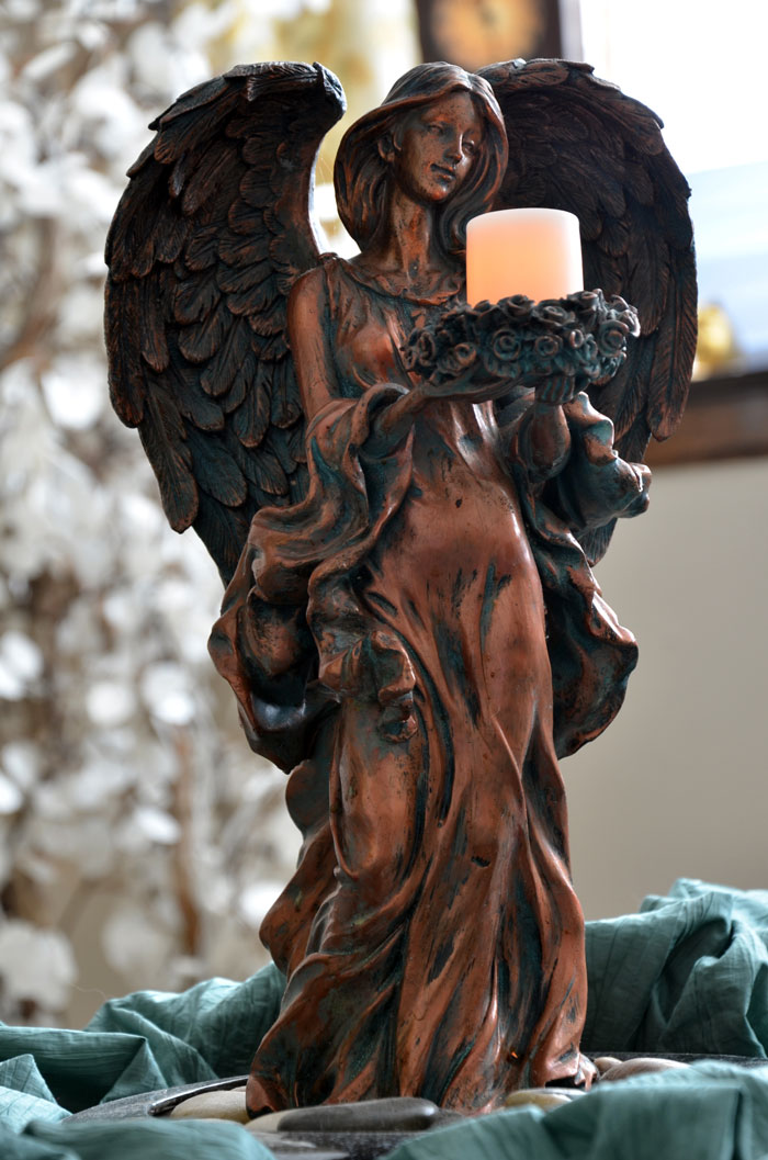 Statuary of an angel holding a candle in Karen's office